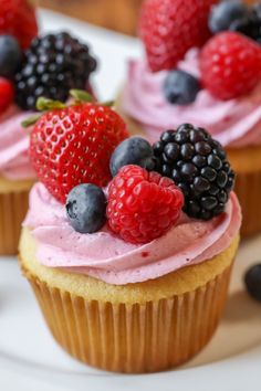 cupcakes with frosting and fresh berries on top