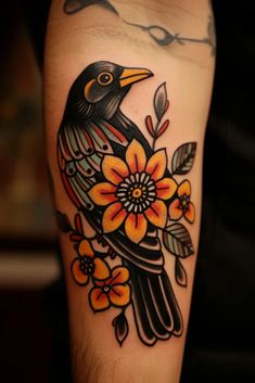 a black bird sitting on top of a flower covered arm with orange and yellow flowers