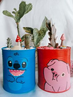 two tin can planters with plants in them