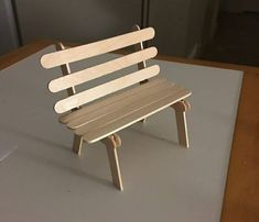 a wooden bench sitting on top of a table