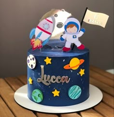 a birthday cake with an astronaut and rocket on top