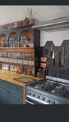 a kitchen with many pots and pans on the shelves