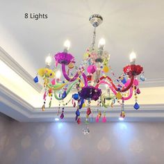 a chandelier hanging from the ceiling in a room with white walls and flooring