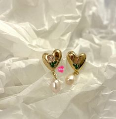 The enamel tulip heart-shaped stud earrings are made with freshwater pearls gold plated. The heart has an enamel tulip pattern on it, which assembles an extra romance and uniqueness. A perfect little something to soften your look and -- MOOD. This bold earring is just right to brighten up your and your loved ones' special moments! It goes well with every style! These easy-to-wear earrings will instantly upgrade all of your favourite everyday looks! Comfortable to wear all day long! -Can be worn Gold Enamel Heart Charm Earrings, Elegant Enamel Heart Earrings For Gift, Elegant Heart Enamel Earrings For Gift, Gold Enamel Heart Earrings For Valentine's Day, Gold Enamel Earrings For Valentine's Day, Gold Heart-shaped Enamel Earrings, Gold Enamel Heart-shaped Earrings, Elegant Heart-shaped Enamel Earrings, Valentine's Day Gold Heart Enamel Earrings