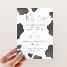 a person holding up a card with the words hello cow on it in gold foil