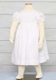 "She will look amazing in a flower girl dress by Zuli Kids. Smocked summer dress is white, smocked in white with delicate pink and green flowers scantly on the front bodice. *Zuli Kids Premium Quality *65% cotton 35% Poly *Machine Wash Gentle *Button-Back Closures *Flutter Sleeves *Classic Smocked Baby Clothes *Available in Sz NB WHATS INCLUDED One smocked dress. RUSH ORDERS We do offer a \"rush service\". If you need your item sooner that expected or just forgot that Thanksgiving is next week, Smocked Dresses For Toddlers, Smocked Baby Girl Dresses, Baby Girl White Dress, Smocked Baby Clothes, 1st Birthday Outfit Girl, Girls Smocked Dresses, Smocked Baby Dresses, Baby Girl Christmas Outfit, Smocked Clothes