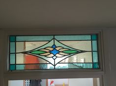 a stained glass window in the corner of a room