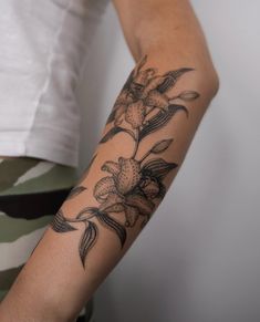 a person with a flower tattoo on their arm