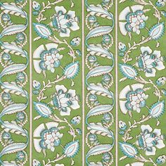 a green and white wallpaper with blue flowers on the side, in an ornate pattern