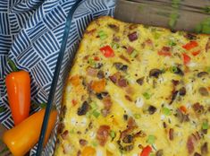 a casserole dish with carrots, peppers and other vegetables on a table