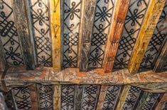 an old wooden ceiling with decorative designs on it