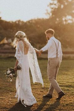 a bride and groom holding hands in the sun