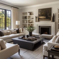 a living room filled with furniture and a fire place in front of a large window