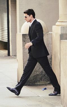 a man in a suit walking down the street