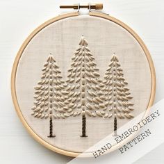 a hand embroidery pattern with three trees on it