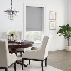 a dining room table with chairs and a chandelier