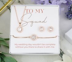 a gift box with three pieces of jewelry in it and the card says to my squad