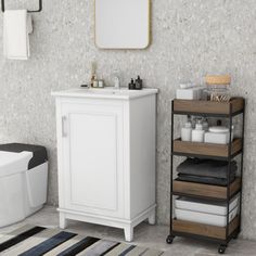 a bathroom with a sink, toilet and bathtub in it's corner next to a towel rack