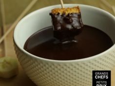 a bowl filled with chocolate and marshmallow sticks