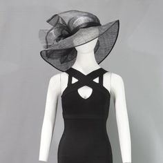 a mannequin wearing a black dress with a hat on it's head