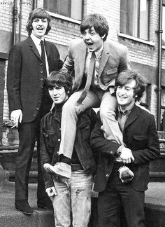 the beatles posing for a black and white photo