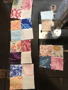 the sewing machine is next to several different pieces of fabric that have been sewn together