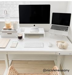 a white desk topped with a laptop computer next to a keyboard and mouse on top of it