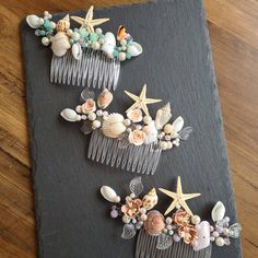 two combs with seashells and starfish on them are sitting next to each other