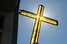 a cross that is glowing in the sun