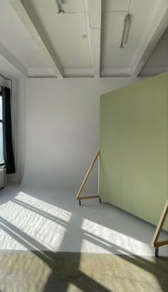 an empty room with white walls and windows