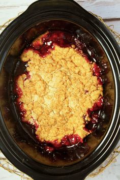 a crock pot filled with food sitting on top of a table