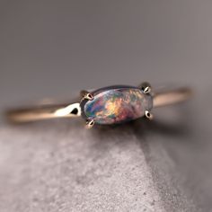 a gold ring with an opal stone on it