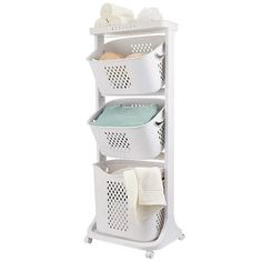 a white shelf with three baskets and towels on it's sides, against a white background