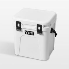 a white yeti cooler sitting on top of a white table next to a black handle