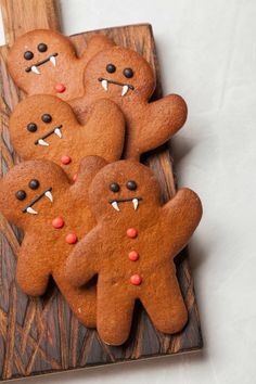 some very cute looking cookies on a wooden board