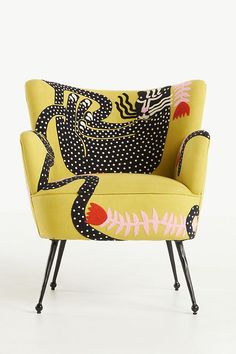 a yellow chair with black and white designs on it