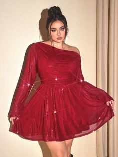 a woman in a red dress posing for the camera with her hands on her hips