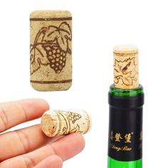 a hand holding a wine cork next to a small bottle opener and an open one