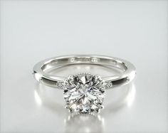 a diamond engagement ring on a white background