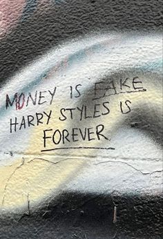 graffiti written on the side of a wall with money is fake harry styles is forever