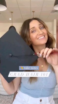 a woman holding up a graduation cap with the words take note grad hair 101