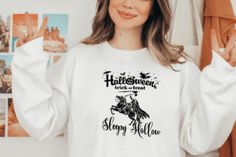 a woman wearing a white sweatshirt with the words happy halloween on it and a black horse