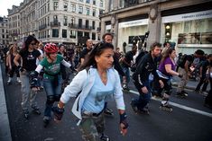 a group of people riding skateboards down a street