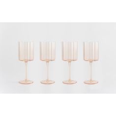 four champagne glasses sitting next to each other