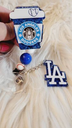 "Dodgers coffee 2 \" Badge Reel available with beads. Beads may vary.  Badge reels are attached with 3M dual lock velcro and are interchangeable. If you prefer a permanent glue please send me a note when you purchase.  Care instructions: Please avoid dropping, while items are durable, they are not indestructible. Please handle with care. Different colors available. Send me a message for customs. RETURNS/EXCHANGES: Due to all items being personalized and made to order we do not accept returns or Novelty Blue Badge Reel As Gift, Customizable Blue Badge Holders For Gifts, Personalized Blue Badge Reel For Gift, Personalized Blue Badge Holders For Gifts, Personalized Blue Badge Holders For Personal Use, Dodger Shirt, Dodgers Shirts, Baseball Gifts, Scroll Saw Patterns