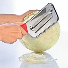 a person using a grater on top of an onion ball with a spatula