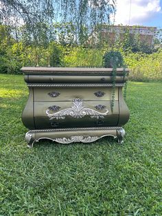 an ornately painted chest in the grass