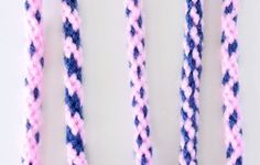 three pink and blue braided ropes on a white surface