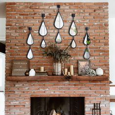 a brick fireplace with several hanging tears on the mantle