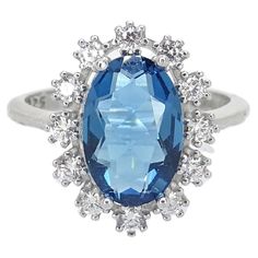 One of a kind Ring / ring with sapphire root, 925 sterling silver and zircons, 20th century – Italy Type: Ring Period: 20th century Setting material: 925 sterling silver Country of origin: Italy Total weight of the jewel: 3.41g. Inner diameter: 17.8 mm. Outer diameter: 20.5 mm. Main stone: 11.5 x 7.6 mm. Cross: 25.5 mm. Exquisite and very refined women's engagement ring made of 925 sterling silver and sapphire root. This oval-cut center stone has an intense blue color and remarkable clarity. It is surrounded by a border of 12 prong-set zircons, which add additional sparkle and sophistication to the design. The term "sapphire root” commonly refers to a variety of corundum, the same mineral family that genuine sapphire belongs to. The deep blue of the center stone contrasts beautifully with Italian Ring, Engagement Rings Romantic, Double Halo Engagement, Platinum Diamond Engagement Rings, Modern Engagement Rings, Ruby Engagement Ring, Three Stone Engagement, Platinum Engagement Rings, Deco Engagement Ring